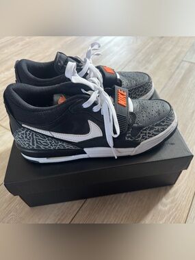 Nike Men’s Black and White Sneakers with Orange Logo Accent
